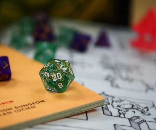 Dice sitting on a dungeons and dragons game board